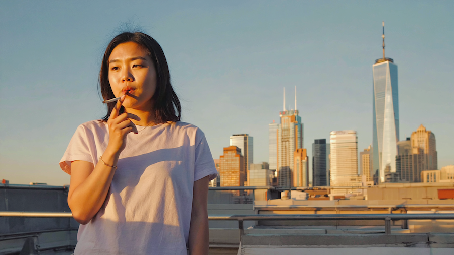 Adults enjoying cannabis on an Atlanta rooftop with skyline backdrop